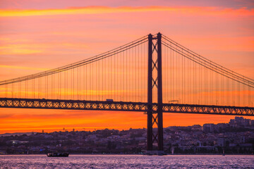 View of 25 de Abril Bridge over Tagus river on sunset. Lisbon, Portugal