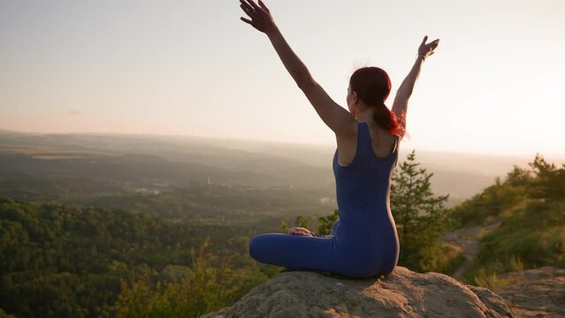 Yoga Session in the Mountains. Young Athletic Woman Exercising in the Rocky Mountains During Sunrise, Doing Various Yoga Poses - Healthy Lifestyle and Zenism Concept. Slow Motion.