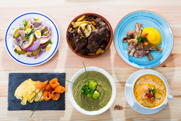 Various dishes of traditional Norwegian cuisine served with vegetables and herbs