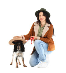 Young woman with cocker spaniel on white background