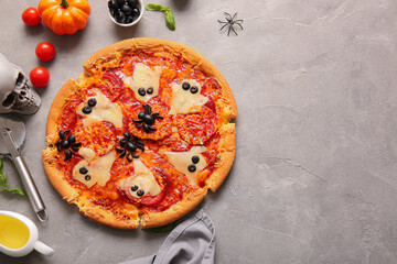 Tasty pizza for Halloween celebration on grey background