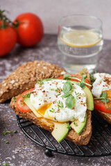 Grid of tasty sandwiches with egg on table