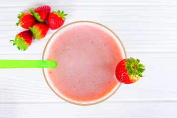 Strawberry yogurt fruit juice smoothie pink colorful fruit juice milkshake blend beverage healthy high protein the taste yummy In glass drink episode morning on white wood background.