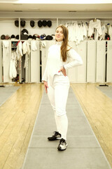 Professional fencer girl with fencing mask and rapier. Training in hall 