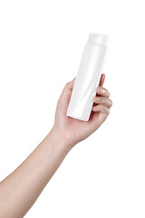 Hand holding a bottle of shampoo isolated on white background.