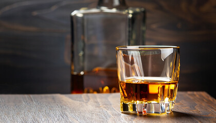 Bourbon in glass, american corn whiskey, dark bar counter, selective focus