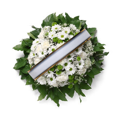 Funeral wreath of flowers with ribbon on white background, top view