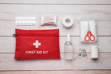 Flat lay composition with first aid kit on wooden table