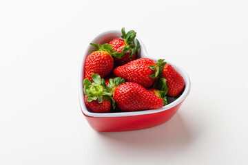 Fresh strawberries in heart bowl