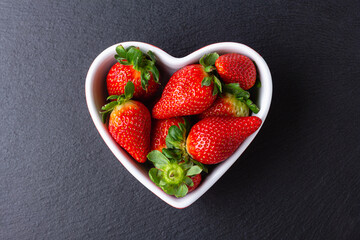 Fresh strawberries in heart bowl