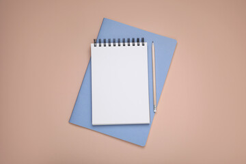 Blank notebook, planner and pencil on beige background, top view. Space for text