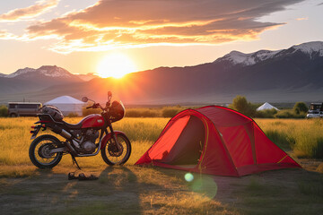 Motorcycle and tent at sunset