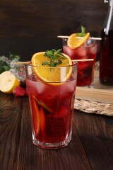 Glasses of delicious refreshing sangria on wooden table