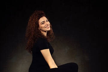 Portrait photos of a young, beautiful, white-skinned and red-haired girl, headshot. Portrait, headshot photos of a young and talented actress candidate, taken on a black background