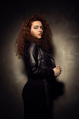 Portrait photos of a young, beautiful, white-skinned and red-haired girl, headshot. Portrait, headshot photos of a young and talented actress candidate, taken on a black background