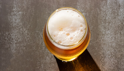 Top view of beer glass with foam cap and copyspace