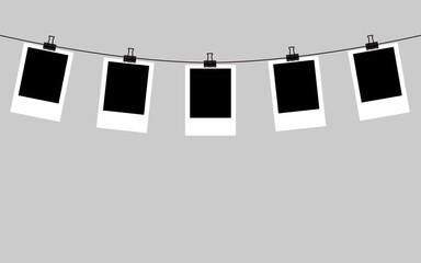 blank polaroid photo frames hanging on rope
