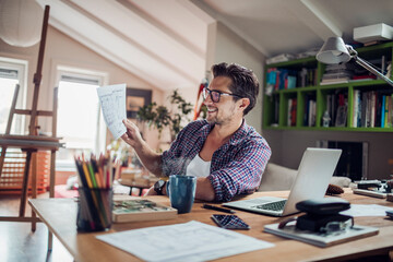 Young man working and using a laptop at home