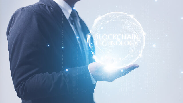 businessman holding global network with hologram blockchain digital technology.