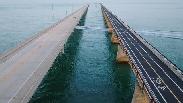 Static aerial view of the Seven Mile Bridge in the Florida Keys with speed boat crossing underneath