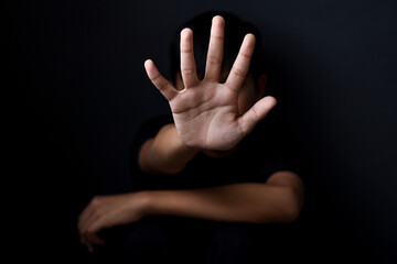 Boy with his hand extended signaling to stop useful to campaign against violence, abuse children  or human trafficking - obrazy, fototapety, plakaty