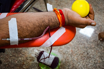 Blood donor at Blood donation camp held with a bouncy ball holding in hand at Balaji Temple, Vivek...