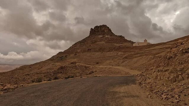 Driving to Ksar Guermessa troglodyte village in Tunisia on cloudy day. Driver point of view