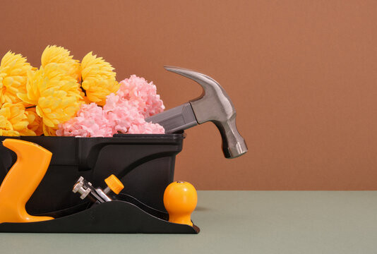 Tool box and flowers. Planer and hammer. Copy space for text.