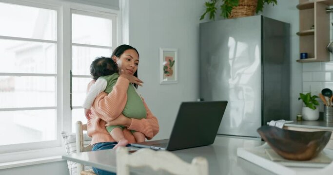 Laptop, remote work and a mother holding her baby in the living room of her home while working as a freelance entrepreneur. Computer, startup and a single parent with her infant child in the kitchen