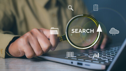 Businessman using magnifying glass search information networking with tablet. Job search, find a job, job interview. Data Search Technology Search Engine Optimization.