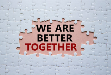 We are better together symbol. White puzzle with words We are better together. Beautiful pink background. We are better together concept. Copy space.