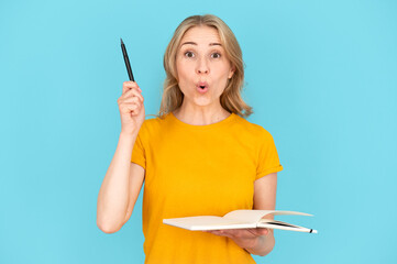 Portrait of female student holding notebook and having good idea