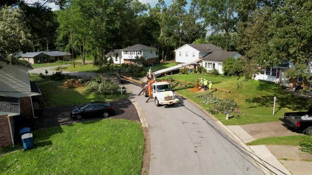 replaing utility pole after storm drone cinematic slow slide up and right