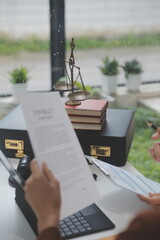 Business and lawyers discussing contract papers with brass scale on desk in office. Law, legal...