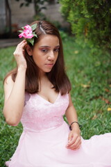 Naklejka premium Beautiful latin hispanic girl in a pink dress for quinceanera celebration in Guatemala