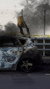 Broken car burns after an accident. The Car After the Fire. Burnt Out Car. Engine Burned Out Car Wreck After a Fire. Vandalism. Car Crash Traffic Accident Scene. Vertical, vertical video background.