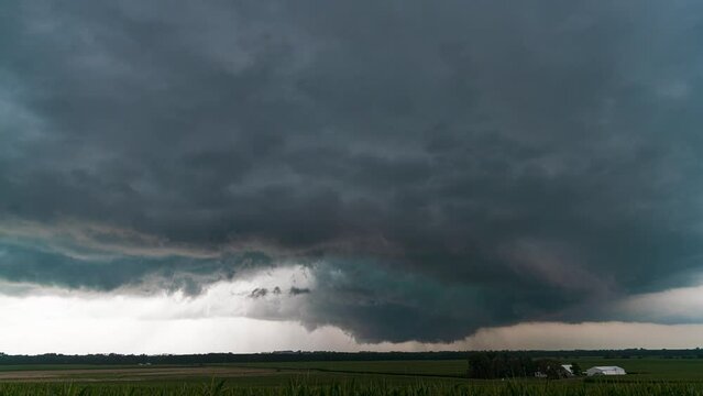 A wall cloud rapidly rotating just before producing a tornado in rural Iowa.