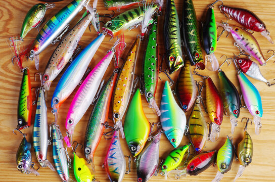 Fishing spinning lures on a wooden texture.