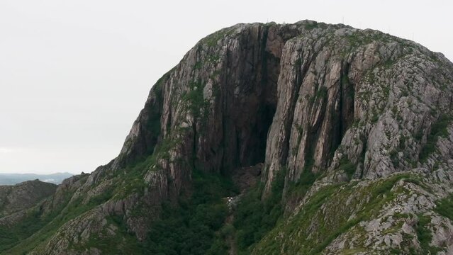 Drone orbit popular Torghatten with famous dark eroded hole through mountain