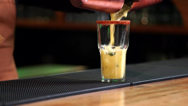Pineapple drink mojito margarita pi&ntilde;a colada daikiri serving on glass from mixer at mexican latin restaurant bar cantina