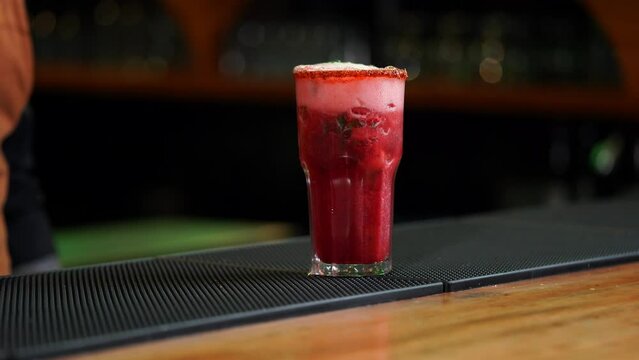 Mexican strawberry mojito daiquiri margarita drink on glass overfilled on bar table mexico latin bar restaurant