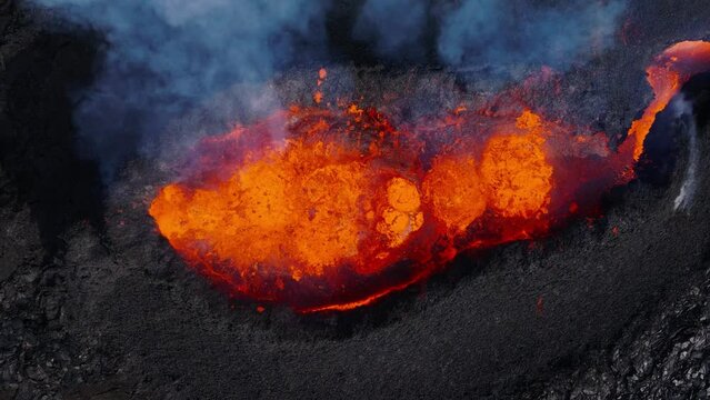 Top down of volcano crater ejecting hot molten lava, fiery explosion