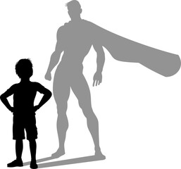 A superhero child or kid boy revealed by his shadow silhouette as a super hero in a cape.