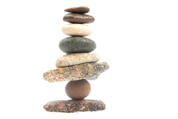 Fototapeta na wymiar pyramid of stacked stones on a white background. stabilization and balance in life