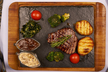 Grilled beef meat and vegetables top view