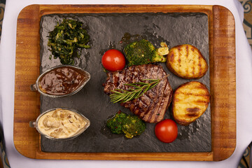 Grilled beef meat and vegetables top view
