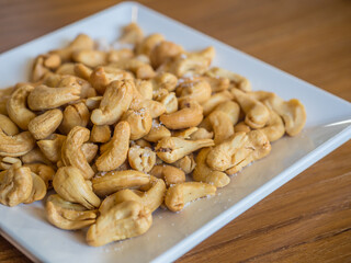cashew nuts in a square white dish