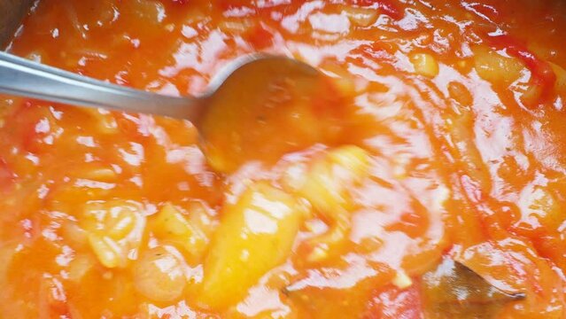 The traditional dish of Hungary and Serbia is becharats or sataras. Boiled vegetables, tomatoes, onions, peppers with spices. Balkan and Eastern European cuisine. Delicious stew is stirred with spoon