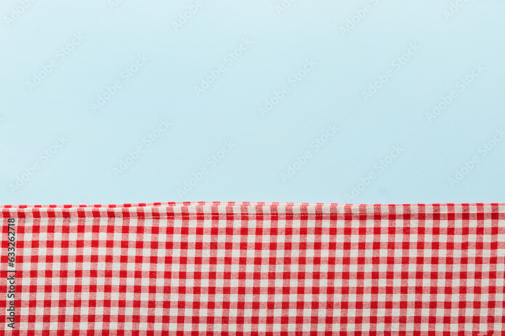 Wall mural top view with red empty kitchen napkin isolated on table background. folded cloth for mockup with co