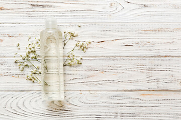 Fancy healthcare bottles for serum, micellar, tonic, toner, lotion, water and cream with gypsophila branch. Natural oranic spa cosmetics concept. Mockup, template, Top view